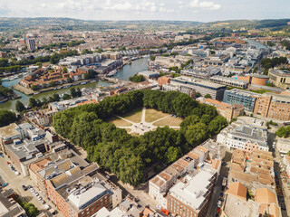 Fototapeta premium Bristol UK: 28th Jul 2025: Drone view of Bristol Queen Square. Prepares for an exciting event with setup taking place in the heart of the city