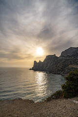 Coastline sunset cliffs reflecting golden light across the sparkling sea