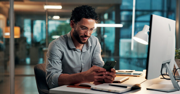 Design, phone and typing with business man at desk in office for development at night. App, computer and text message with creative designer in dark workplace for communication or online planning