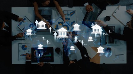 A collaborative business meeting featuring professionals analyzing financial data and visualizations from laptops and papers, showcasing global trends and insights. Raster