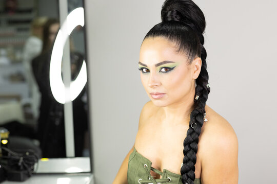 Beautiful European woman getting artistic makeup applied by a professional makeup artist in a modern beauty salon, glamour and elegance concept. - Powered by Adobe