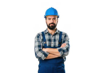A bearded construction worker wearing a blue hard hat and blue overalls stands confidently with arms crossed isolated on transparent background