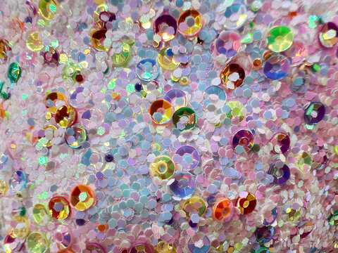 Colorful iridescent sequins in close-up abstract glitter pattern