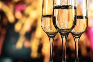 Two glasses of champagne against a backdrop of fireworks