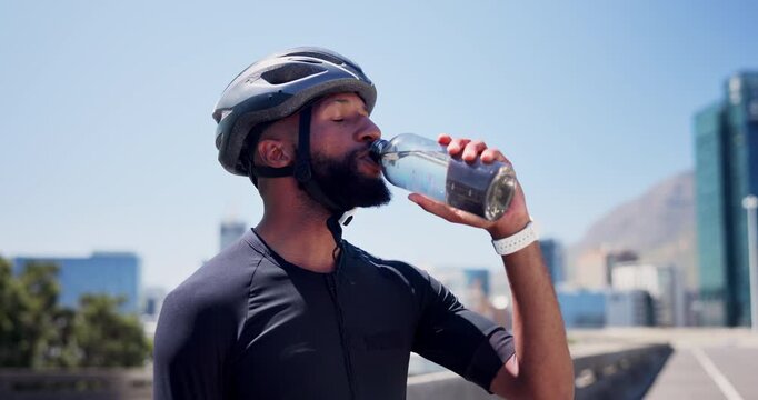 Man, cyclist and drinking water with bottle in city for hydration, workout break or rest. Active, male person or mineral liquid with aqua, beverage or nutrition for exercise or recovery in urban town
