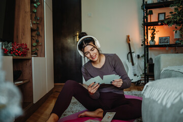 Woman relaxing at home, reading oracle cards for mindfulness