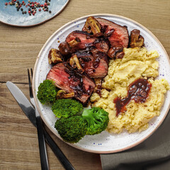 Sliced Medium Rare Steak with Mashed Potatoes and Broccoli