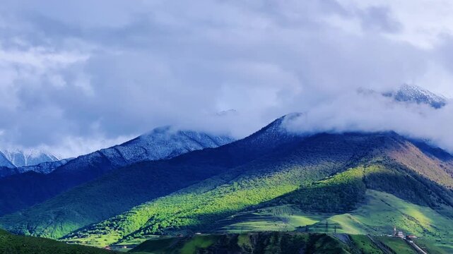 The Green Valley of the Karmadon Gorge with a view of the Kolka Glacier. The Main Caucasian Range. A summer view of the Karmadon Gorge. A mountain valley after a rock and ice collapse. Snowy peaks.4K	