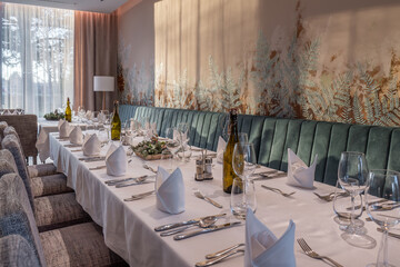 Elegant dining room with decorated table and wine bottles
