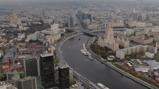 High-altitude drone zoom toward riverbend skyline, Dlog footage