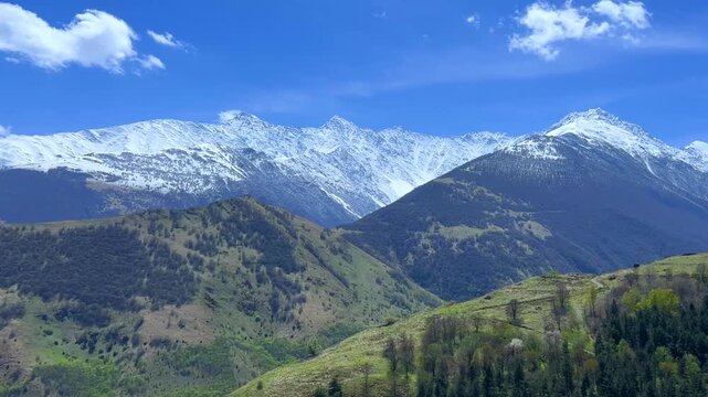 The Green Valley of the Karmadon Gorge with a view of the Kolka Glacier. The Main Caucasian Range. A summer view of the Karmadon Gorge. A mountain valley after a rock and ice collapse. Snowy peaks.4K