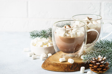 Christmas hot chocolate or cocoa with marshmallow on white with christmas decorations.