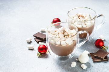 Christmas hot chocolate or cocoa with marshmallow on white with christmas decorations.