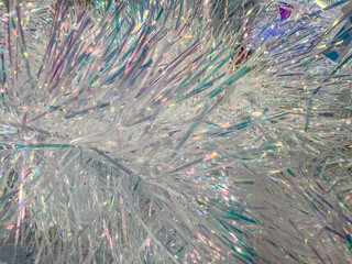 Obraz premium Glittering iridescent tinsel close-up with sparkling light reflection