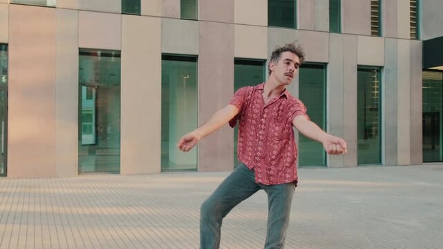 Man Dancing in Front of Modern Building