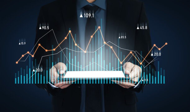 Businessman in formal attire presents a tablet displaying dynamic digital graphs. Ideal visual for concepts related to financial analysis and market trends. Scalp - Powered by Adobe