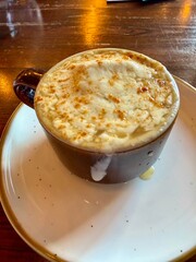 French onion soup topped with melted cheese in a ceramic mug