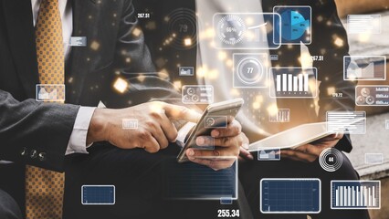 Business professionals interact with digital devices in a modern office, showcasing technology role in finance and data analysis for effective decision-making. Xenic