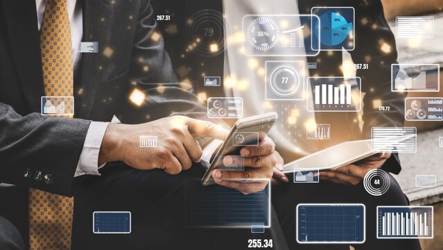 Business professionals interact with digital devices in a modern office, showcasing technology role in finance and data analysis for effective decision-making. Xenic