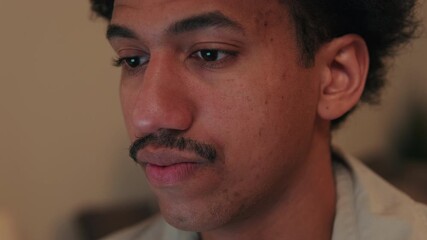 Young Man Lost in Thought while working on laptop