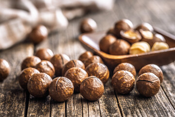 Tasty macadamia nuts on wooden table.