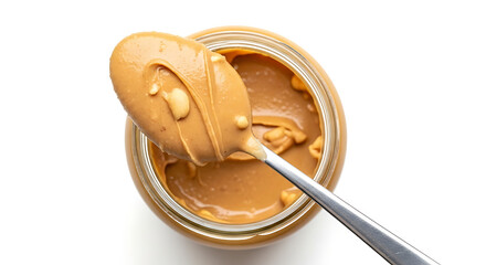 Creamy peanut butter scooped from a jar with a spoon