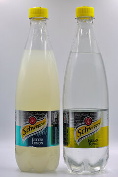 Schweppes Bitter Lemon and Indian Tonic water bottles closeup on white.