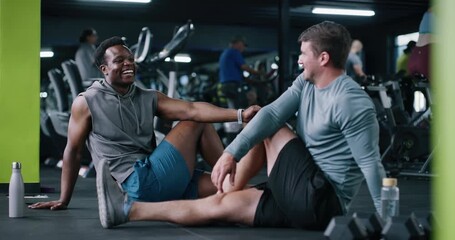 People, talk and stretching for fitness at gym with exercise, training and flexibility routine. Friends, discussion and warm up to prepare muscles, mobility workout and improve posture for wellness