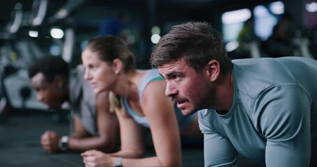 Fitness, man and plank with group in gym for training, workout or breathing for wellness on floor. People, core exercise and friends in health club for balance, abs and intense challenge for strength - Powered by Adobe