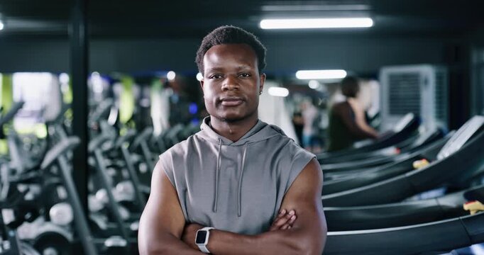 Arms crossed, fitness and face of man in gym for workout, challenge and sports athlete. Strong, exercise and training coach with person in wellness club membership for about us and bodybuilder