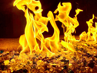 Closeup of a fire in a home fireplace with glowing embers and dancing flames