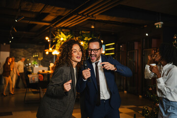 Colleagues singing karaoke during an office party celebration