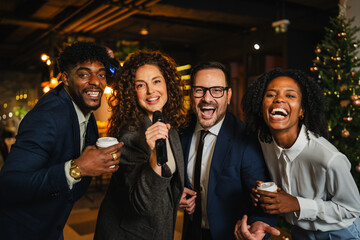 Diverse colleagues celebrating party night singing karaoke