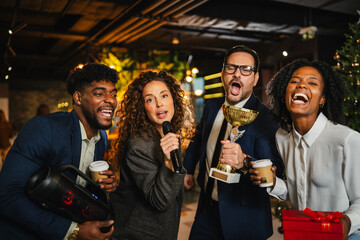 Diverse business colleagues celebrating successful team building with karaoke
