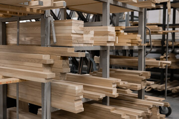Stacked lumber fills a warehouse, showcasing a neat and orderly arrangement. Concept of resourcefulness, construction, or sustainable forestry is conveyed.