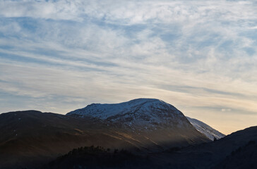 Sunset glow casting light across Lake District peaks.
