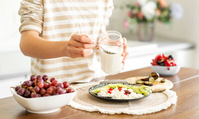 Girl Decorating Cottage Cheese With Berries