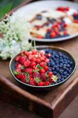 Delicious rare wild berry -  musk strawberry, bilberry,  strawberry, wild cherry - soft fruit foraging. Summer delicacy,  luxury, gourmet food.