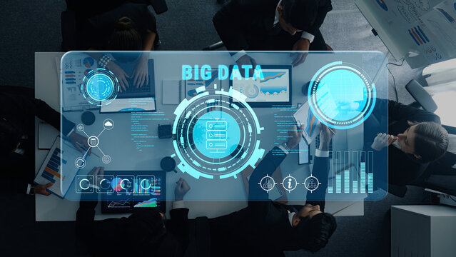 A modern business meeting showcasing a big data analytics interface, digital displays, and team collaboration in a contemporary office environment. Trope - Powered by Adobe