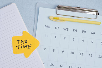 Tax time reminder on calendar and notepad highlighting financial deadline