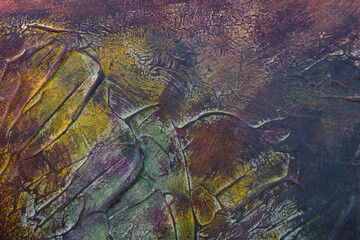 Abstract vivid brush stroke patterns blend together to form a dynamic textured artistic grunge styled painted background
