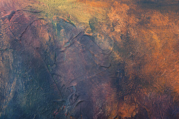 Abstract vivid brush stroke patterns blend together to form a dynamic textured artistic grunge styled painted background