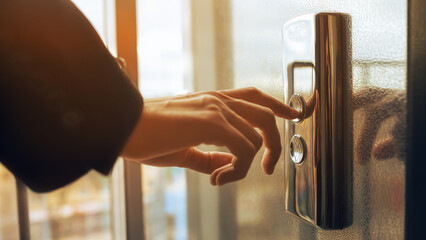 Close-up. A human finger presses an elevator button. A man's hand indoors. A red button. Concept of technology. © maxbelchenko