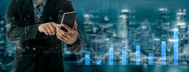 A businessman in a suit engages with a smartphone while analyzing financial graphs against a vibrant city backdrop, symbolizing growth and modern business strategies. Scalp