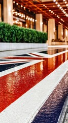 The Union Jack flag painted on a water feature in front of a building with lights