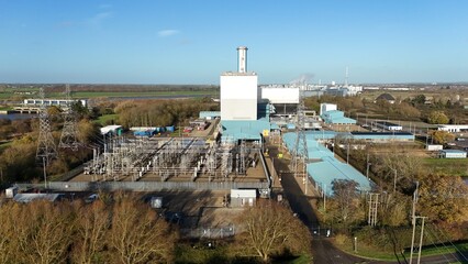 Aerial view of the Kings Lynn Power Station, a monumental structure against a clear sky, with intricate power lines stretching across the landscape, King's Lynn, England, United Kingdom.