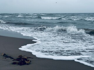 Wellen auf der Landzunge Grenen nahe Skagen in D&auml;nemark an einem wolkigen und windigen Tag