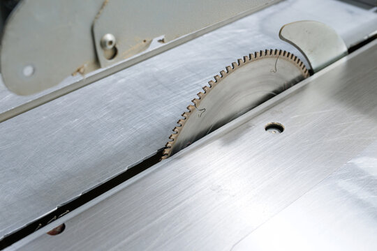 Close up of circular table saw blade in industrial woodworking workshop