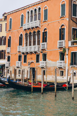 Gondolas floating past traditional Venetian buildings in Venice Italy