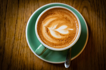cup of latte top down view with froth art
